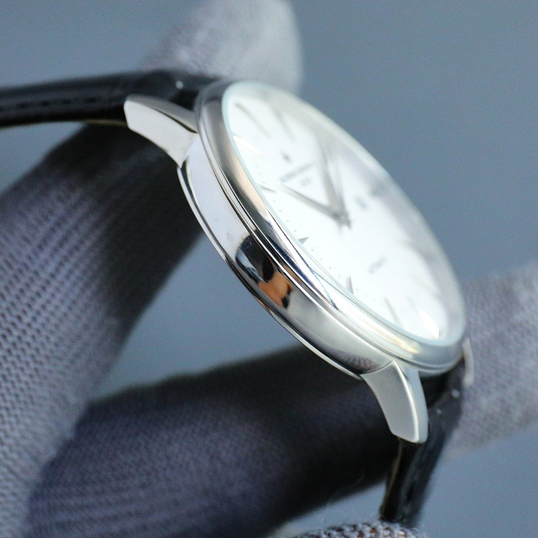 Wristwatch case profile with crown and metal lugs on black leather strap