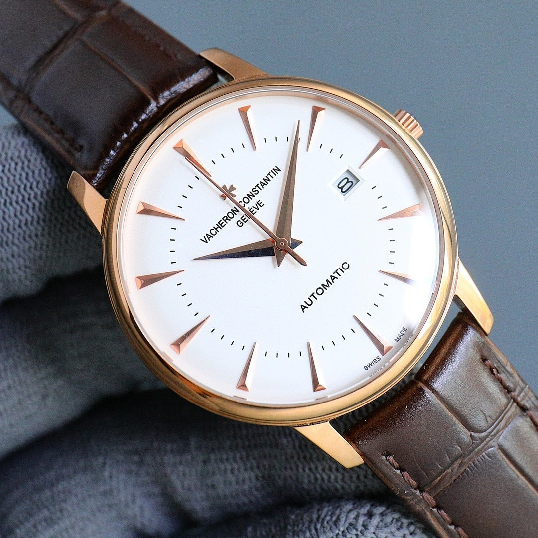 Automatic wristwatch with white dial, gold-toned case, brown leather strap, date window