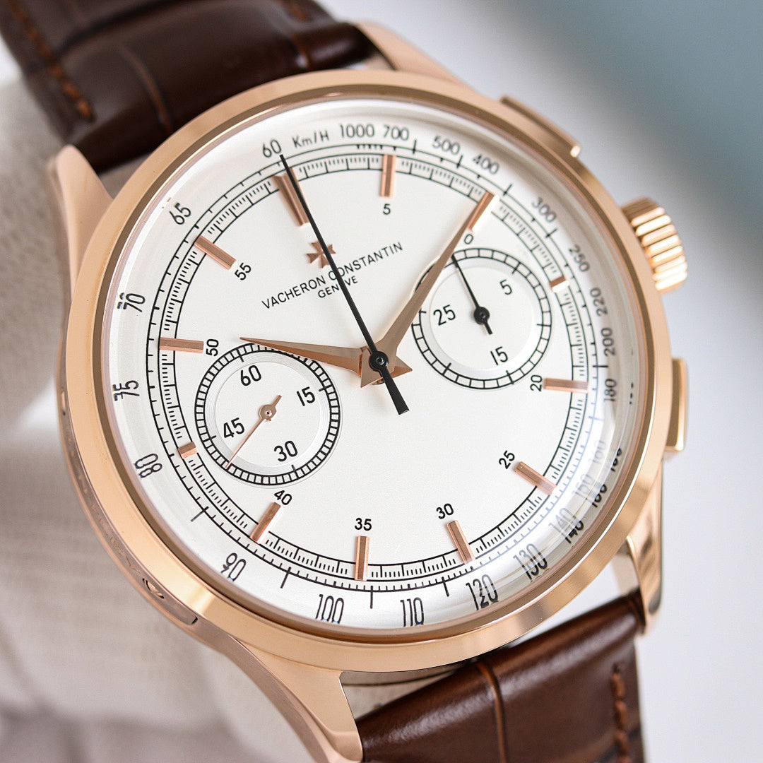 Close-up of round wristwatch face with brown leather strap and white chronograph dial