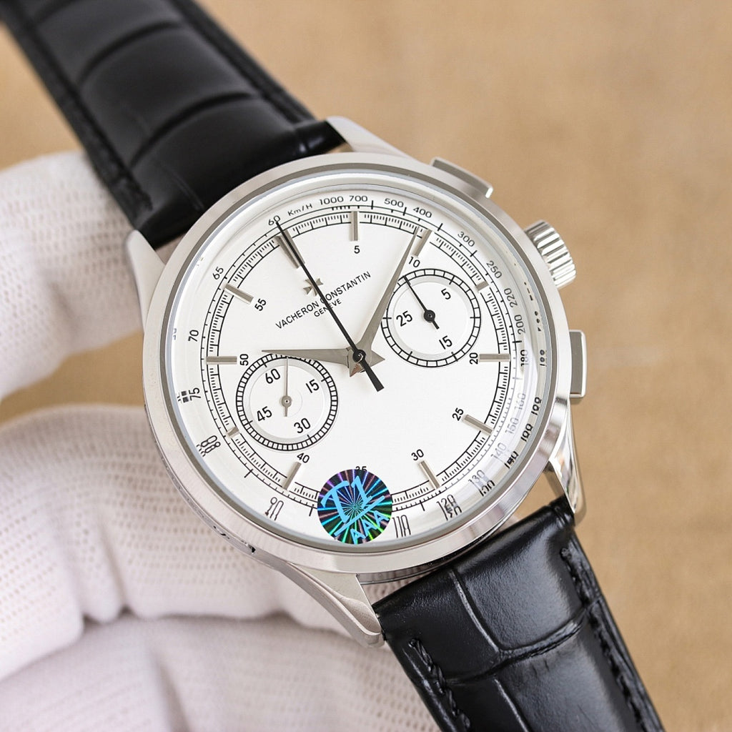 Vacheron Constantin watch, white dial with blue emblem, black leather strap, silver chronograph bezel