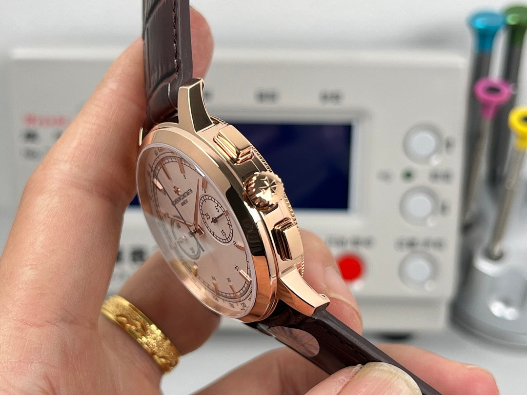 Rose gold tone chronograph watch with white dial and brown leather strap, side view