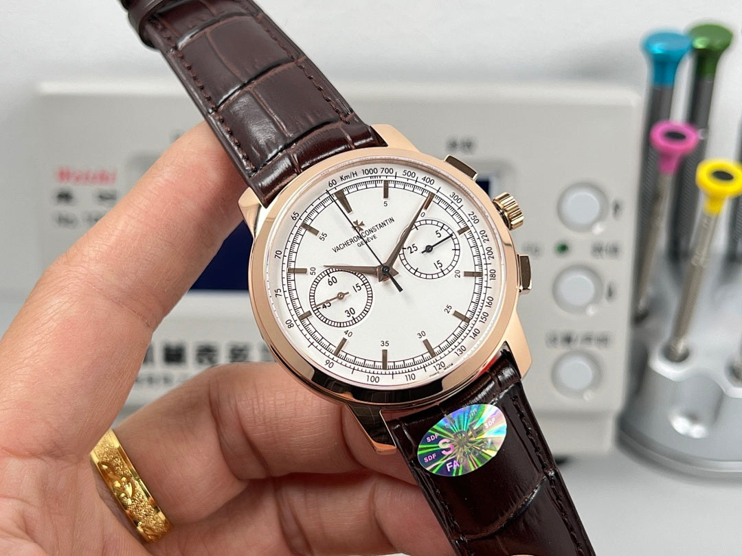 Rose gold tone chronograph watch with white dial and brown leather strap, angled view