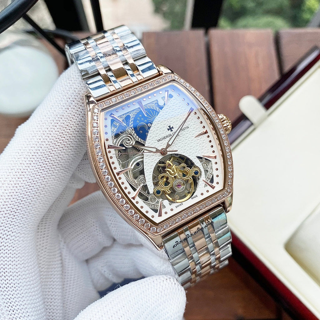 Gold-and-silver automatic wristwatch with diamond bezel and white skeleton dial