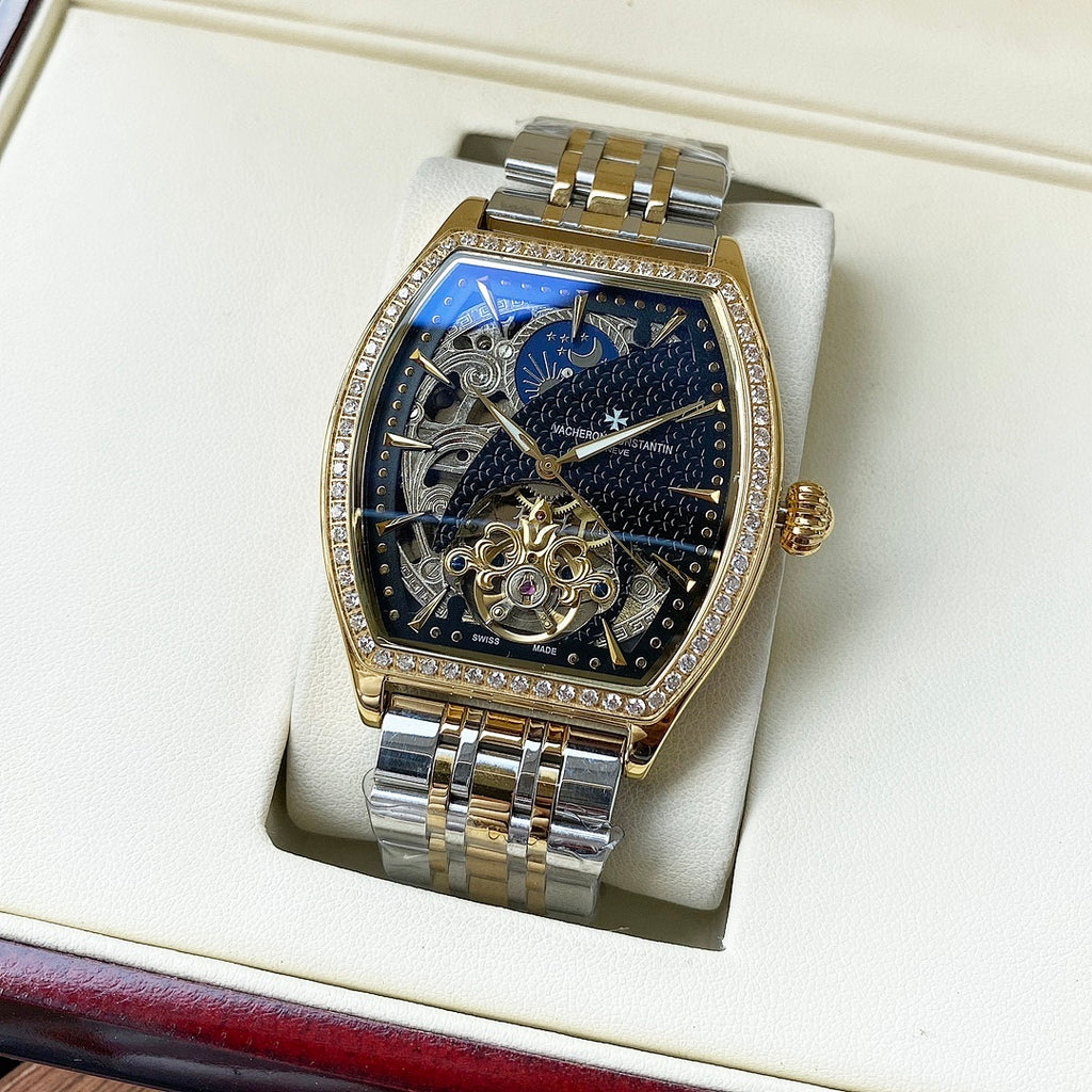 Gold-and-silver automatic wristwatch with diamond bezel and blue-and-white skeleton dial