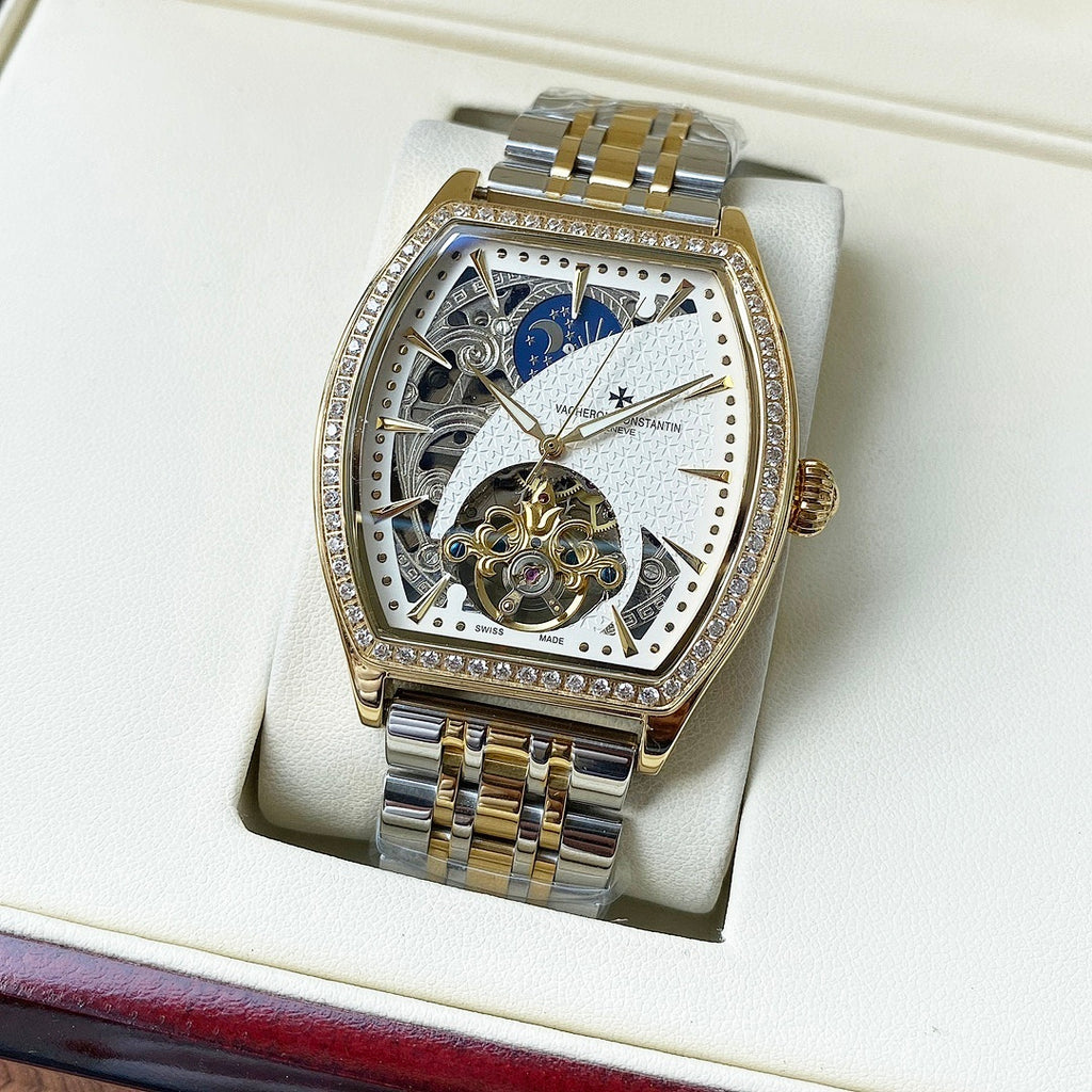 Gold-and-silver automatic wristwatch with diamond bezel and blue-and-white skeleton dial
