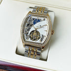 Gold-and-silver automatic wristwatch with diamond bezel and blue-and-white skeleton dial