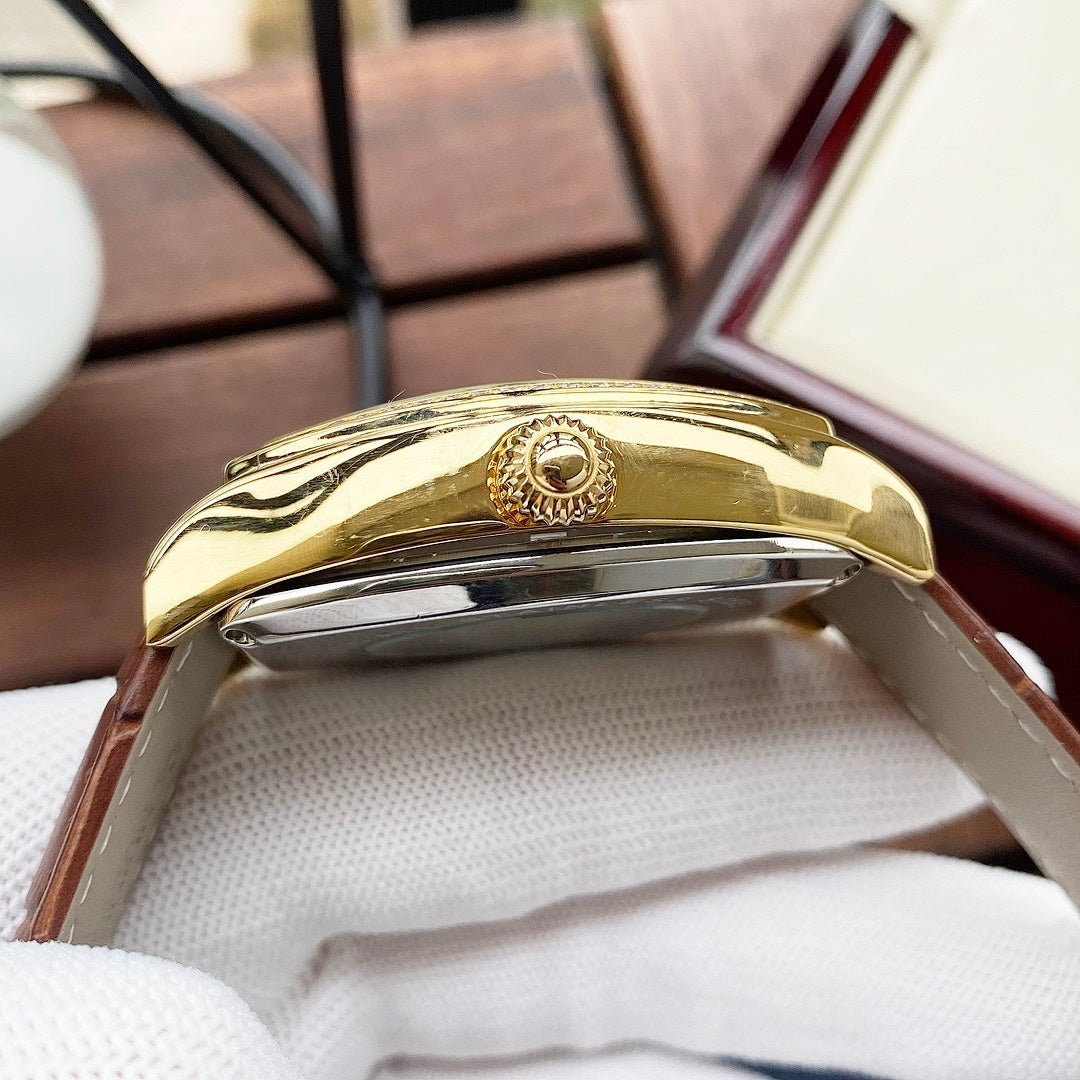 Wristwatch side view with gold-tone case and polished metal crown