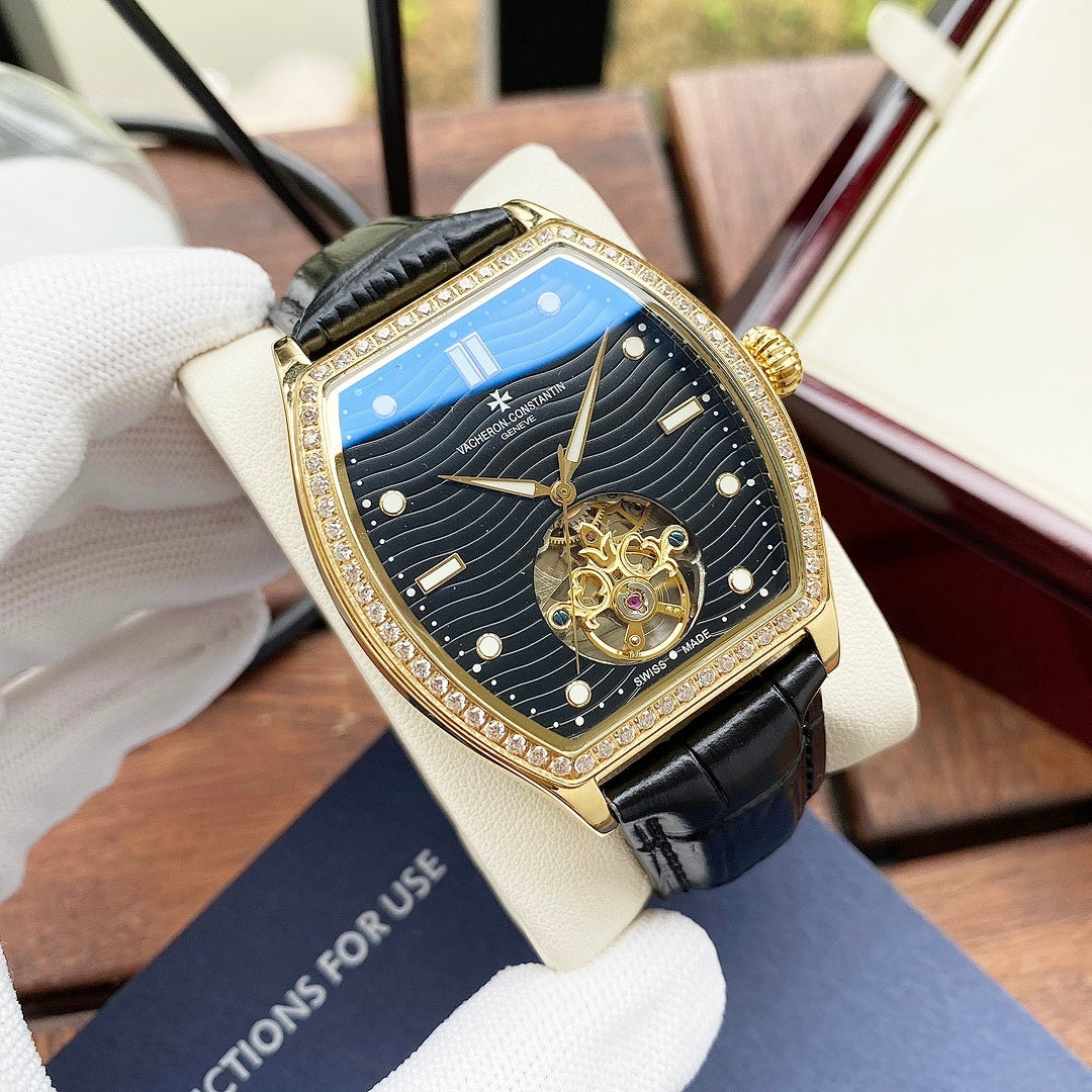 Wristwatch with blue dial, gold-tone bezel, black leather strap