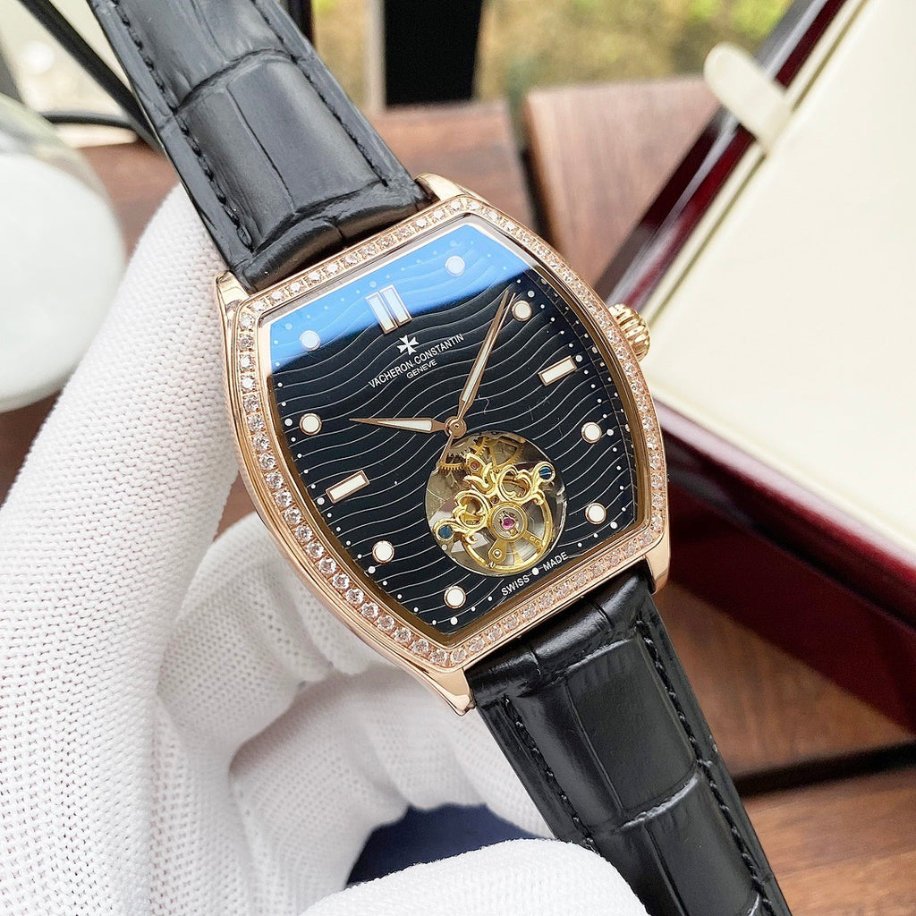 Wristwatch with blue dial, gold case, black leather strap, angled view