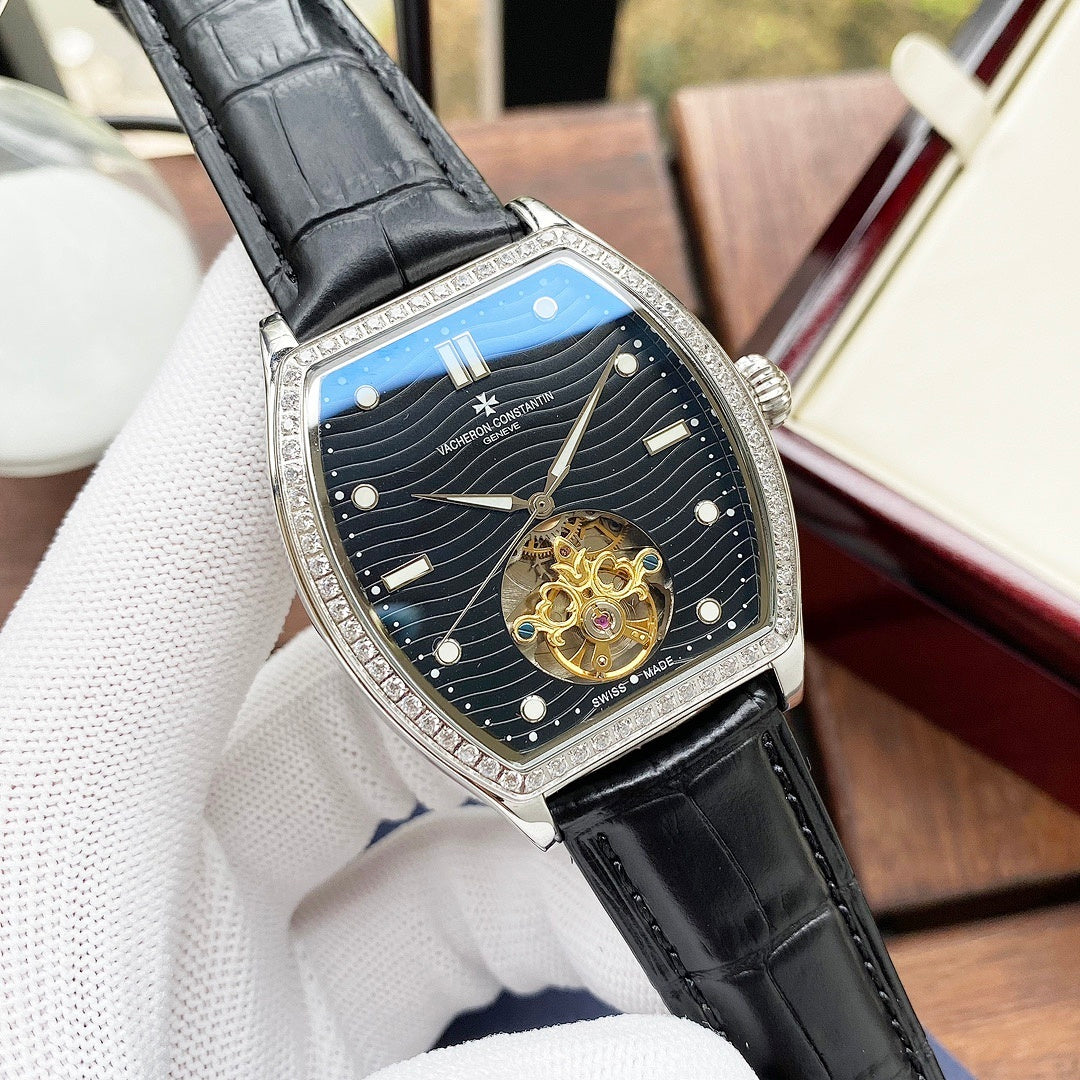 Wristwatch with blue dial, gold case, black leather strap, angled close-up