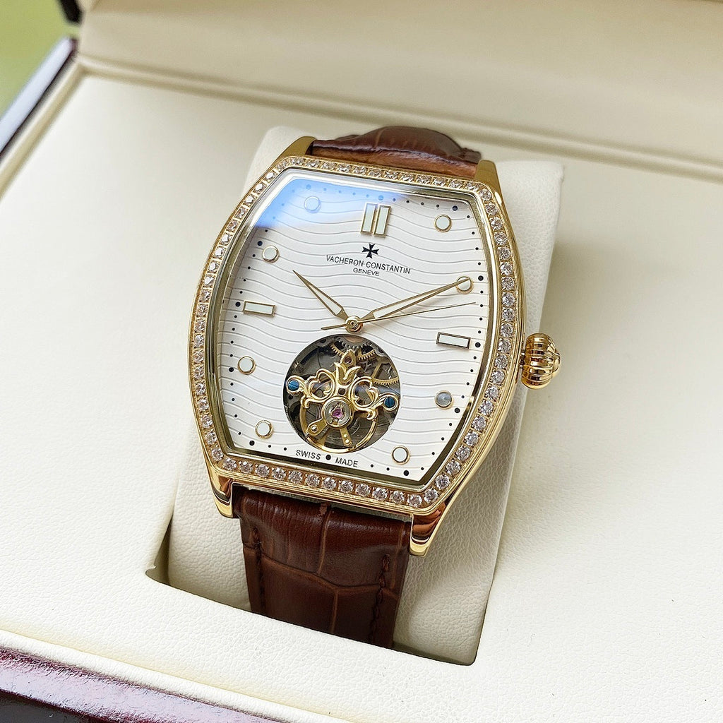Wristwatch with white dial, gold-toned bezel, brown leather strap