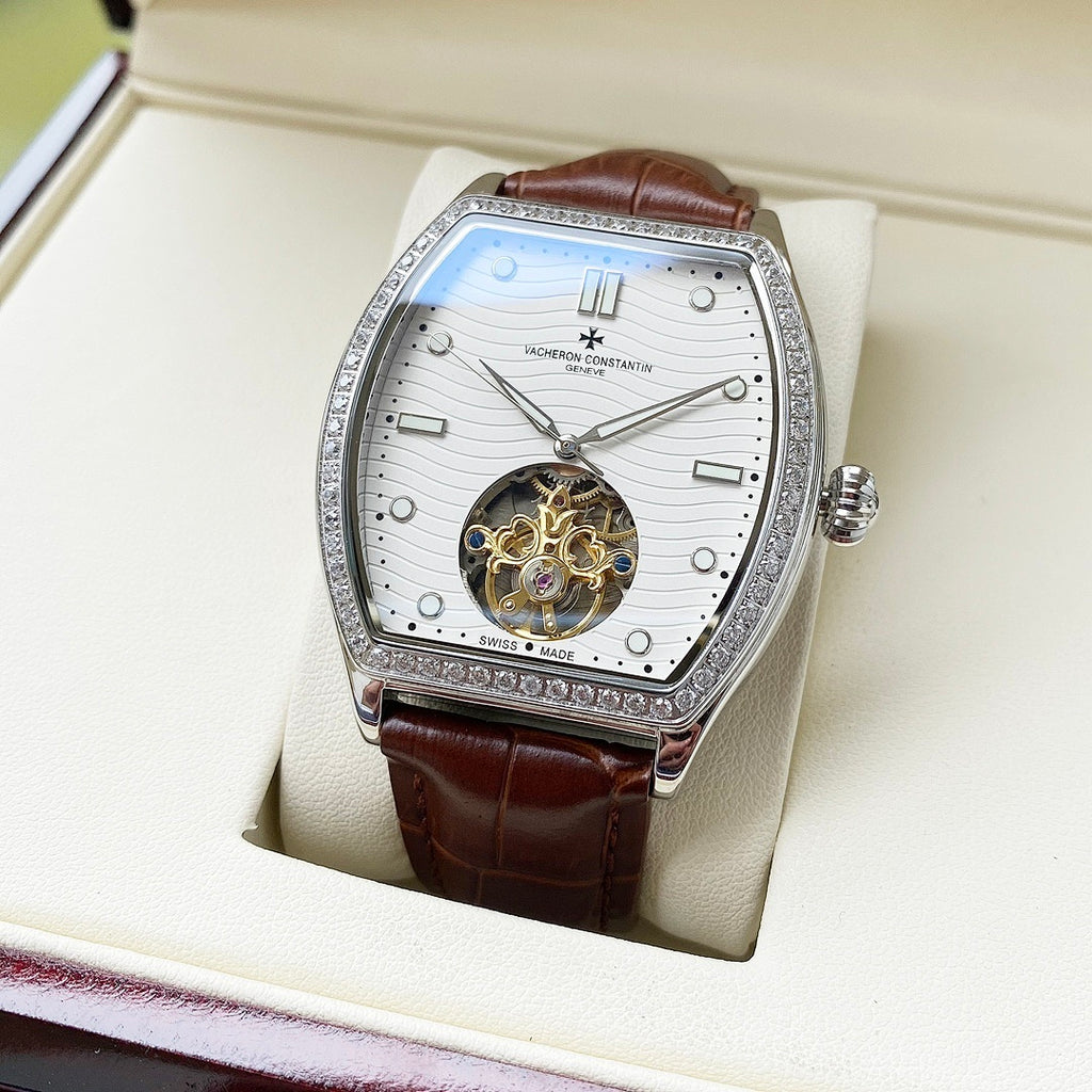 Wristwatch with white dial, silver jeweled bezel, brown leather strap on display