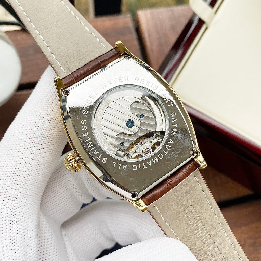 Wristwatch case back on brown leather strap, gold-tone with engraved text