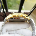 Gold-tone wristwatch with domed crystal, crown detail, and two-tone metal bracelet.