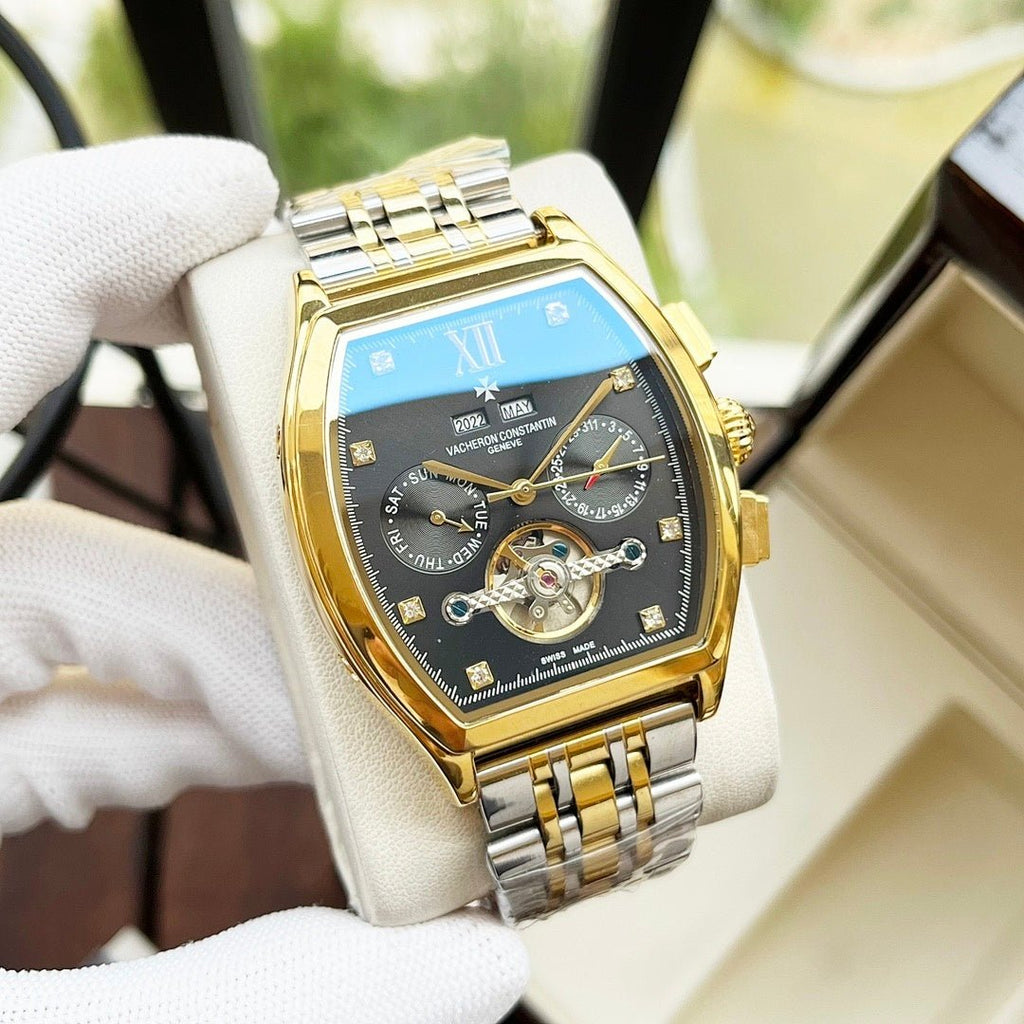 Two-tone men's wristwatch with blue dial and gold bezel on metal bracelet.