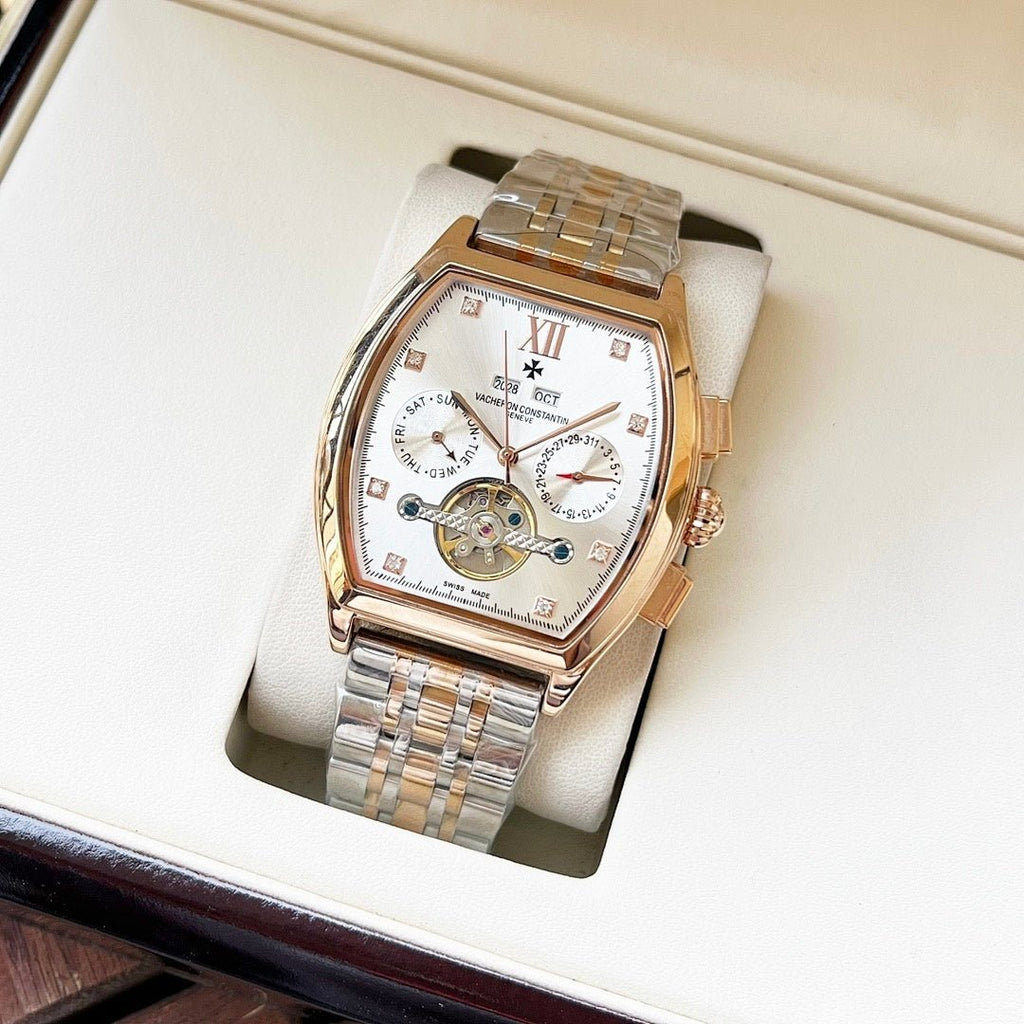 Two-tone men's wristwatch with white dial, Roman numerals, and silver metal bracelet in box.