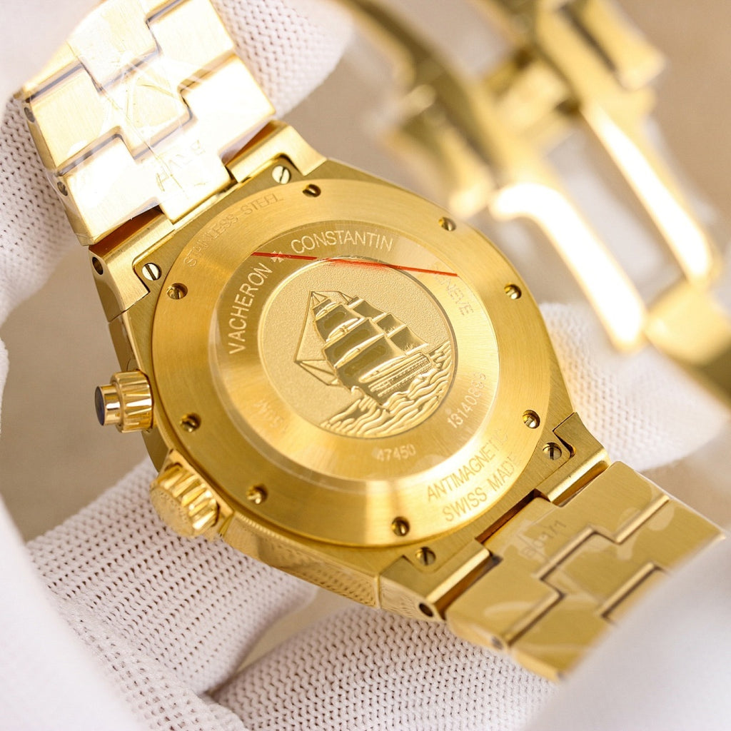 Gold case back with engraved pattern, black strap and watch crown visible