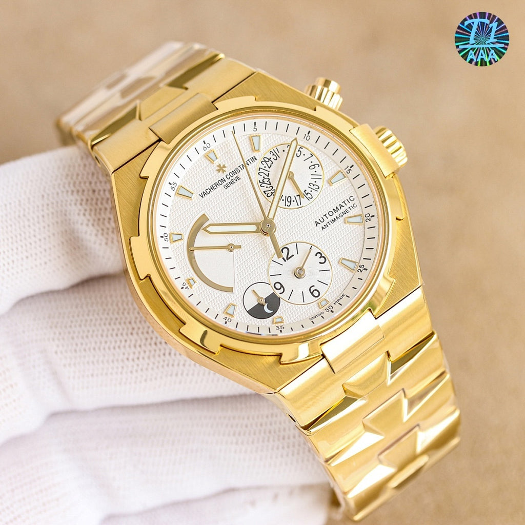 Gold automatic watch with white dial, black rubber strap, dial subdials visible