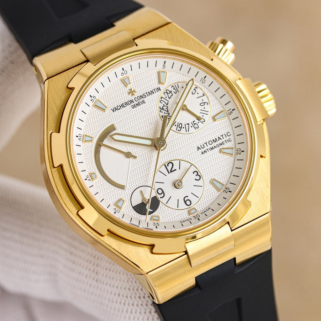 Gold automatic watch with white dial and black rubber strap, close-up front