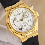 Gold automatic watch with white dial and black rubber strap, close-up front