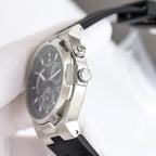Stainless steel watch case with crown and black rubber strap, side profile