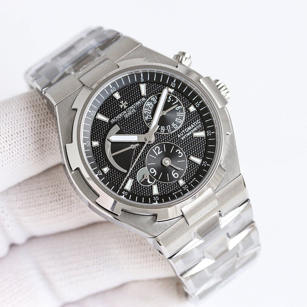 Vacheron Constantin watch with black dial, steel bezel, and steel link bracelet