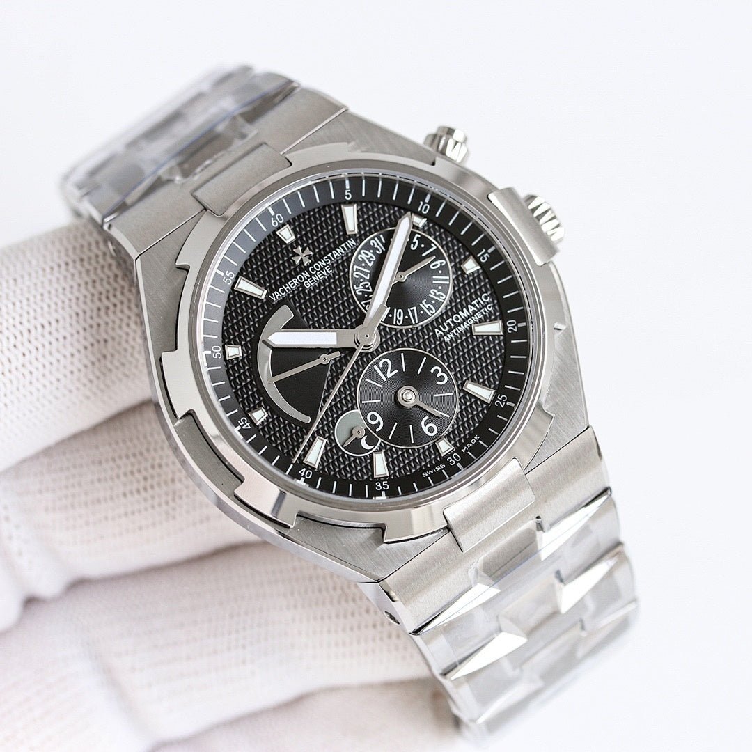 Vacheron Constantin watch with black dial, steel bezel, and steel link bracelet