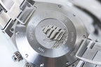 Stainless steel watch caseback with engraved emblem and model text