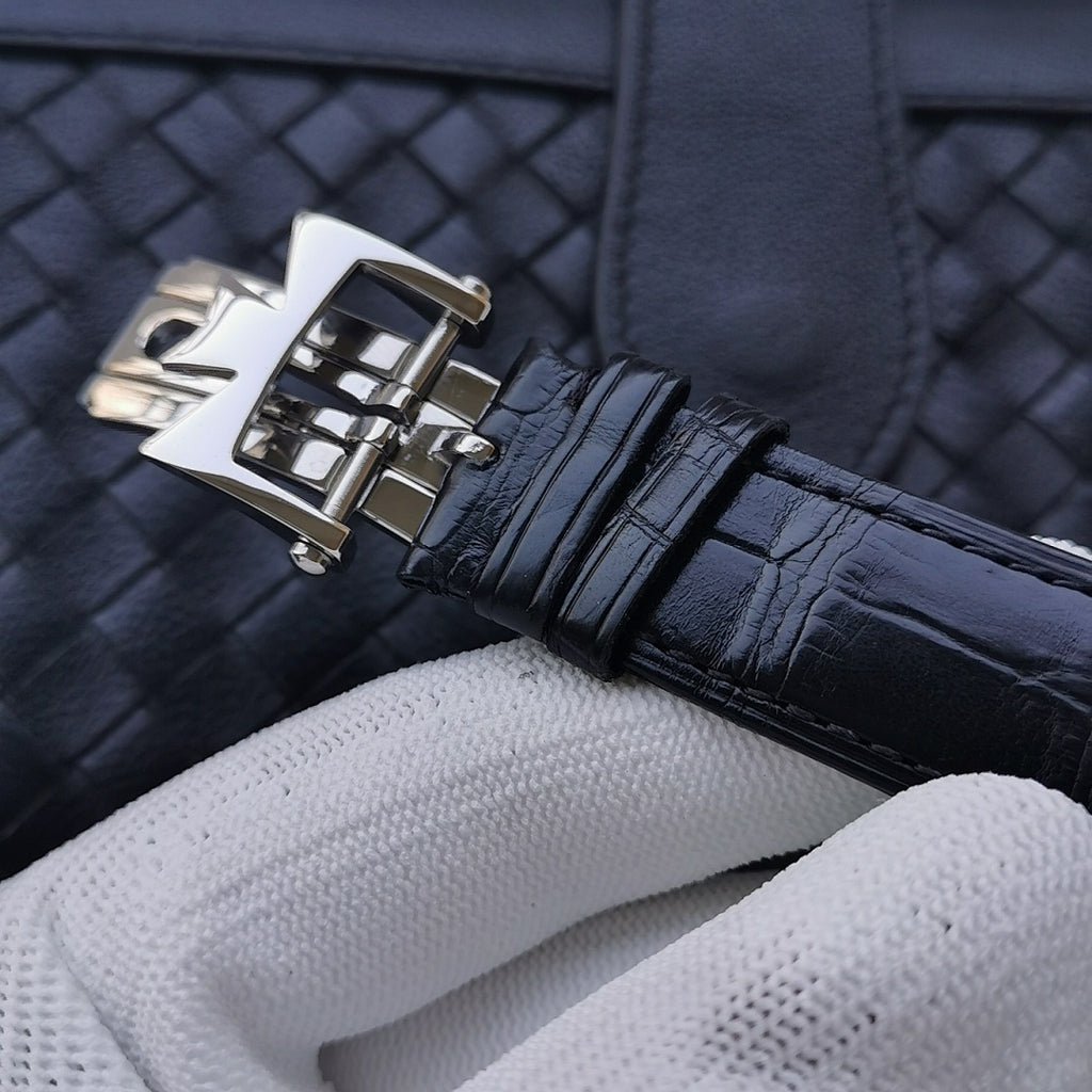 Stainless steel deployment clasp on navy leather watch strap