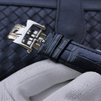 Stainless steel deployment clasp on navy leather watch strap