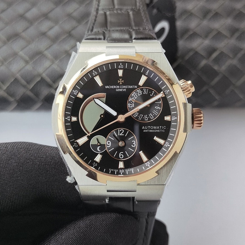 Vacheron Constantin watch with black dial, two-tone bezel, and black leather strap