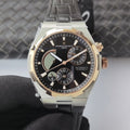 Vacheron Constantin watch with black dial, two-tone bezel, and black leather strap