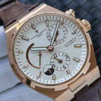 Luxury automatic watch with gold-tone case, white dial, brown leather strap