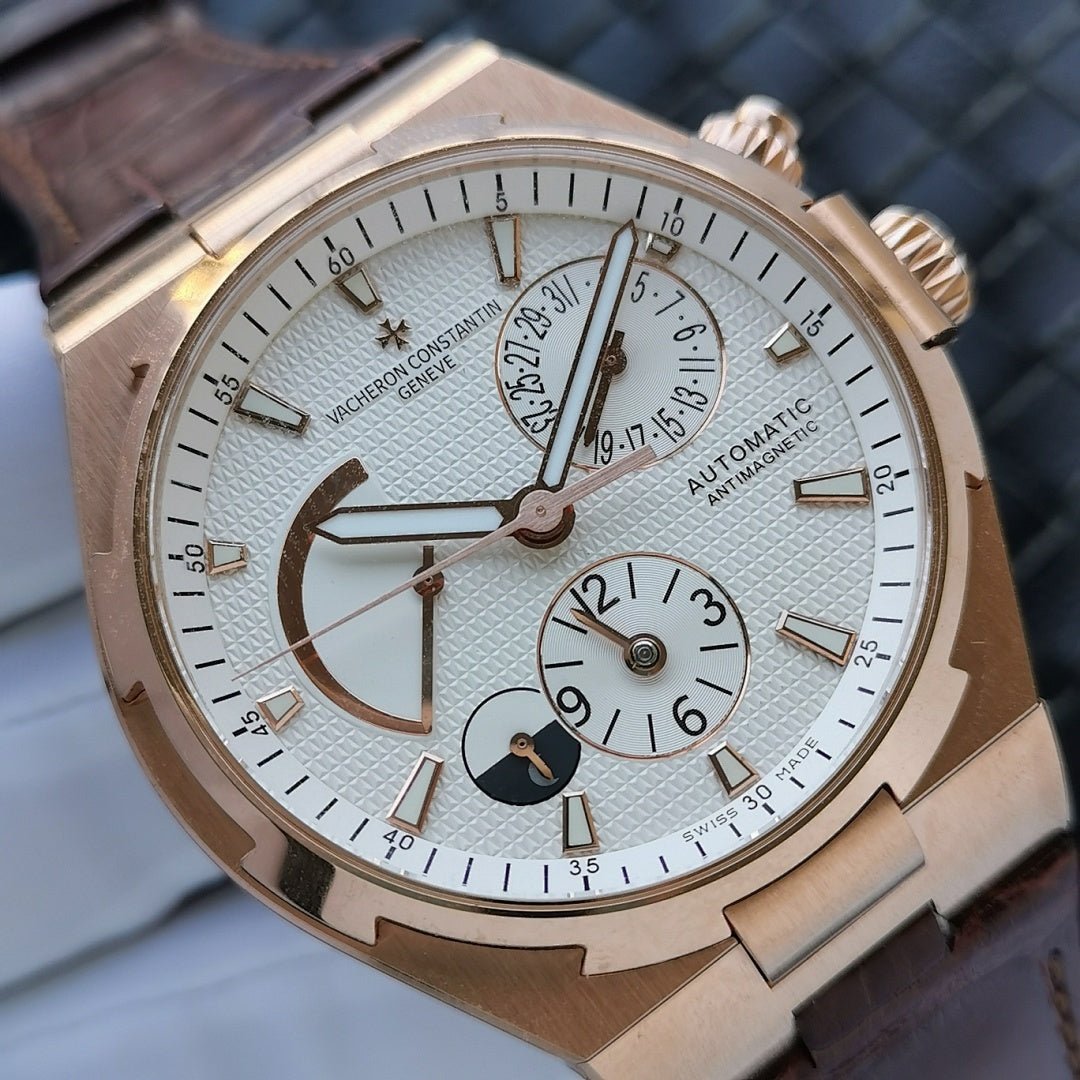 Luxury automatic watch with gold-tone case, white dial, brown leather strap