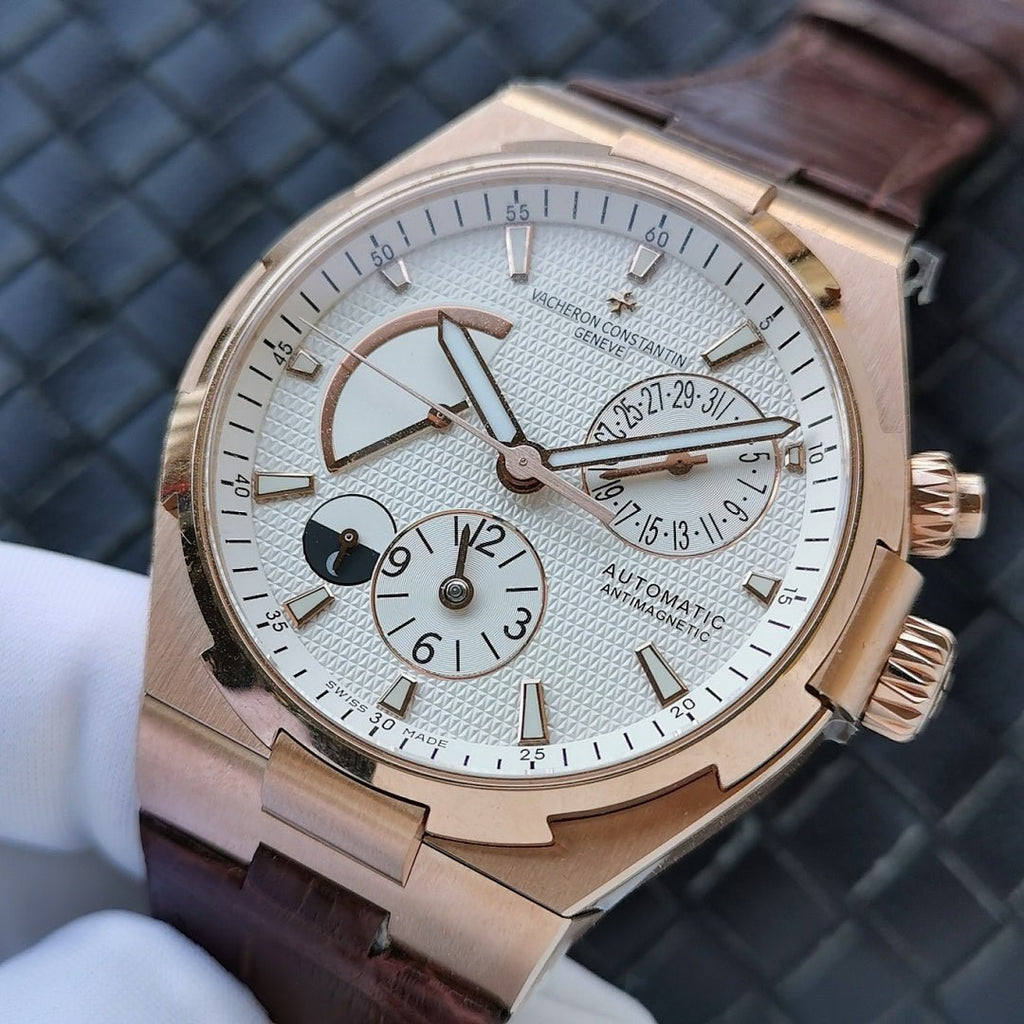 Automatic watch with gold-tone case, white dial, brown leather strap, subdials