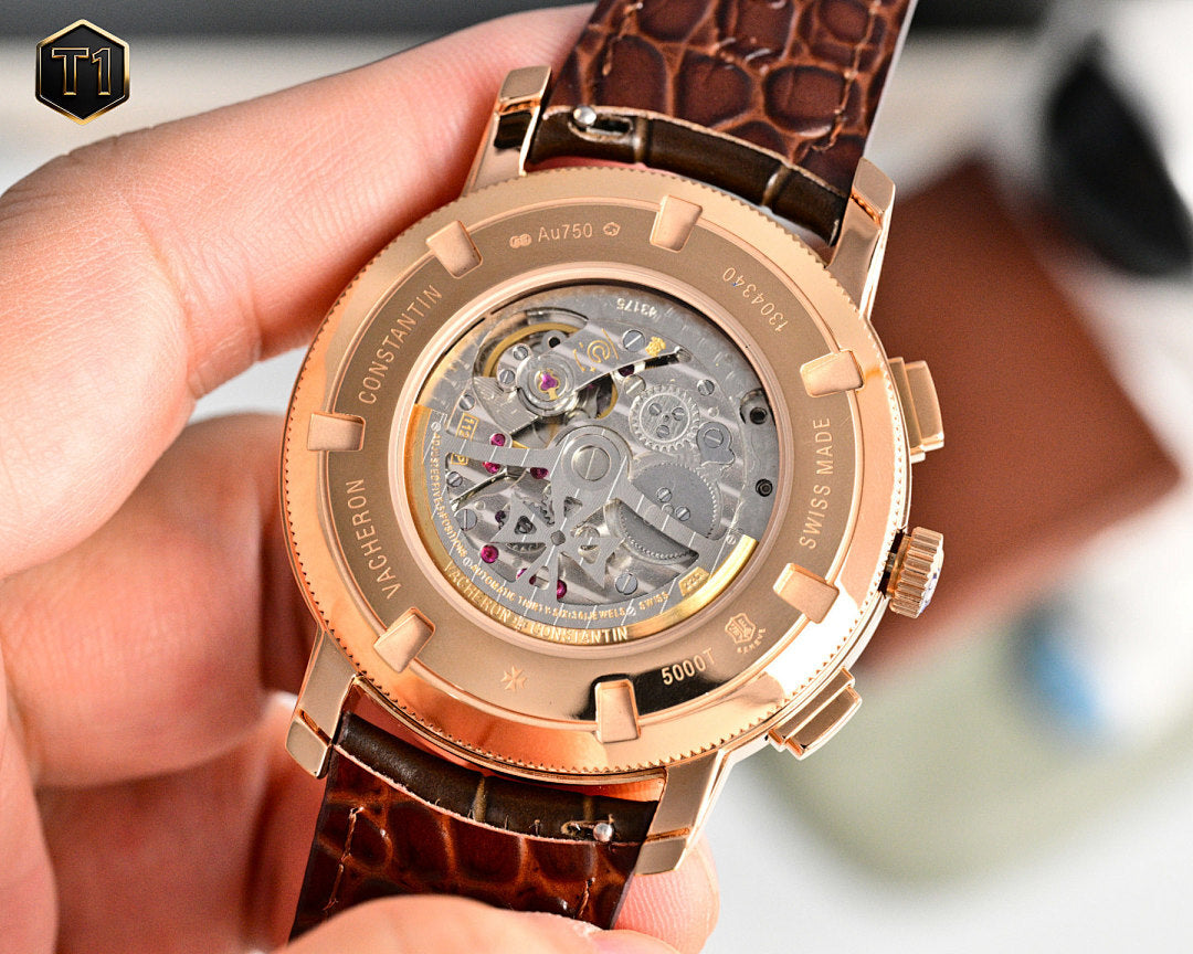 Rose gold wristwatch case back with visible mechanical movement and brown leather strap