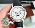 Round wristwatch with white dial, black leather strap, silver bezel and side crown.