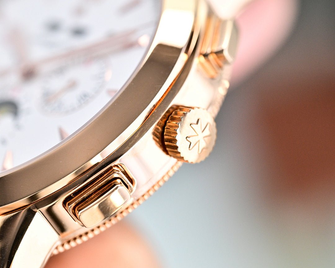Vacheron Constantin wristwatch crown detail on gold-tone bezel, white dial edge