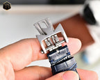 Men's wristwatch buckle and clasp with blue leather strap, silver metal hardware