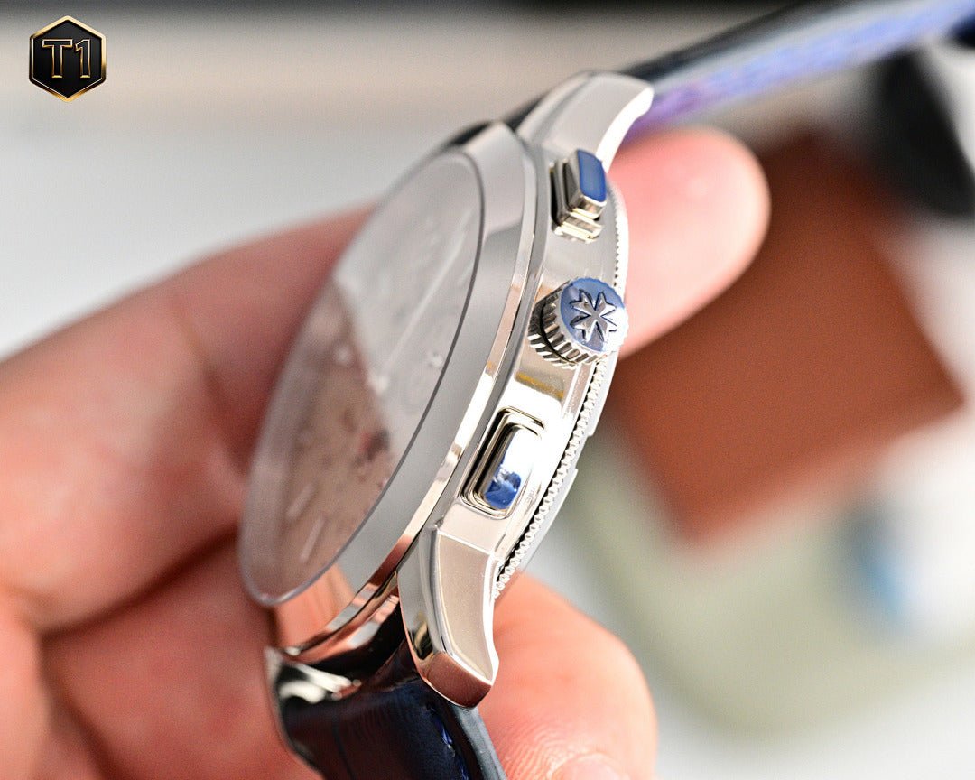 Men's wristwatch side view with silver case and crown, blue emblem on the bezel
