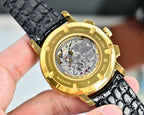 Gold-tone wristwatch case with see-through sapphire back, black leather strap
