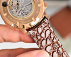 Rose-gold watch case side with textured brown leather strap and buckle area