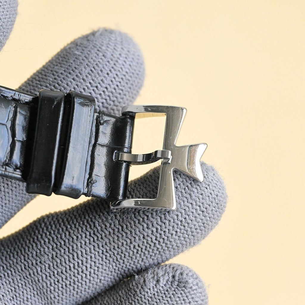 Luxury wristwatch buckle with black leather strap and silver clasp