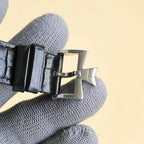 Luxury wristwatch buckle with black leather strap and silver clasp