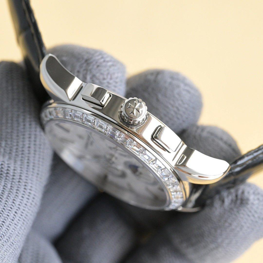 Luxury wristwatch crown and clasp area with black leather strap and diamond bezel