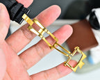 Gold watch clasp and strap end, black leather with gold buckle hardware