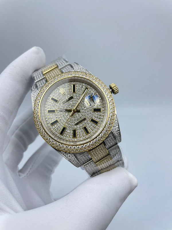 Two-tone diamond dial wrist watch close-up with gold crown and silvertone link band