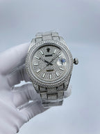 Rolex diamond bezel watch with silver bracelet, dark dial, baton markers