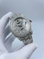 Diamond bezel watch with silver dial, baton indexes, crown at 3 o'clock