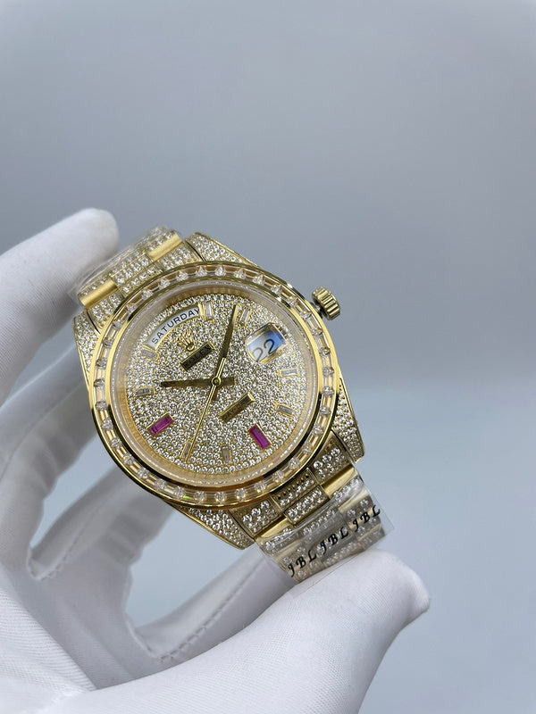 Rolex watch angled front view with gold-tone case, diamond-look bezel and day/date.
